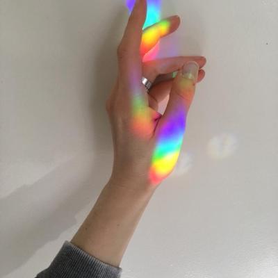 A hand with a reflected rainbow shining on it